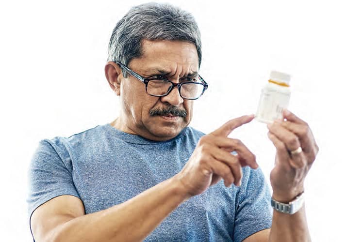 man looking at a prescription